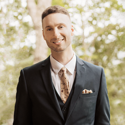 Racine, WI Substitute Teacher, Justin Beaton in a suit looking forward